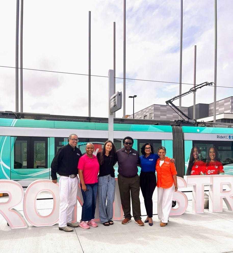 Guests standing together in front of the streetcar