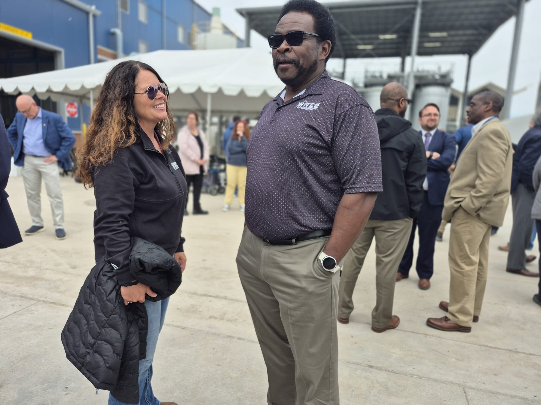 WITEC attendee talking with a guest outside the facility