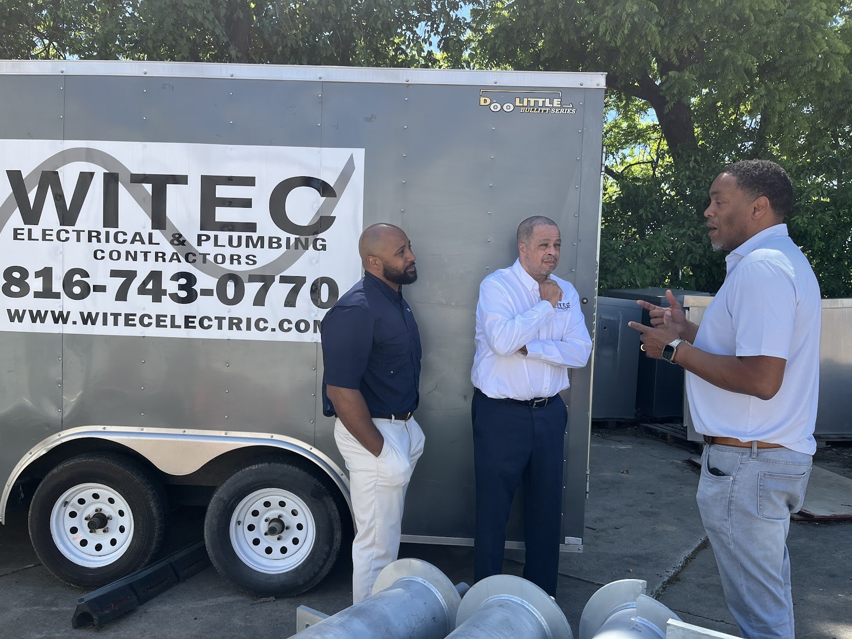 Site conversation beside the WITEC trailer