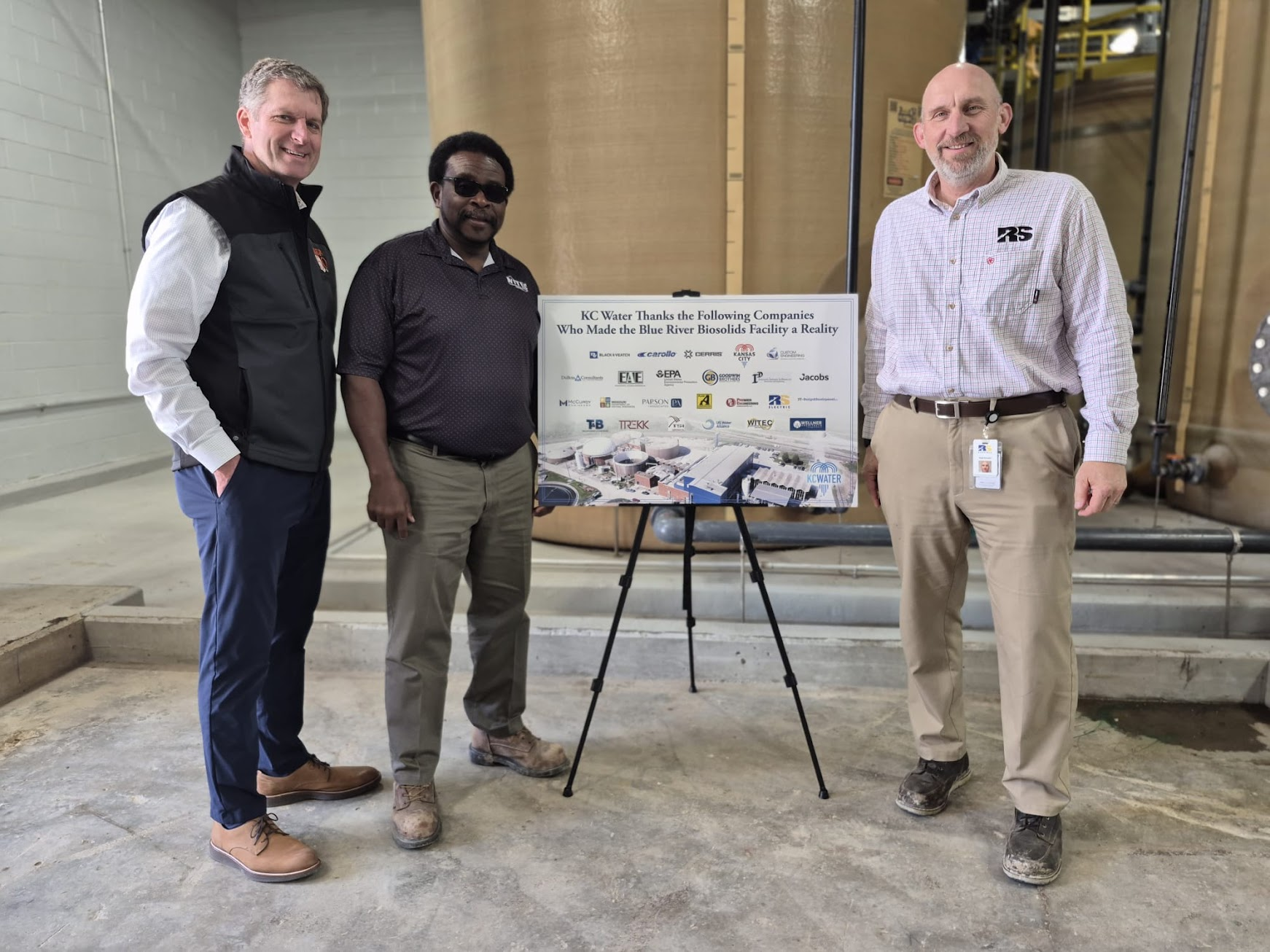 Three attendees beside the KC Water Blue River Biosolids Facility appreciation sign