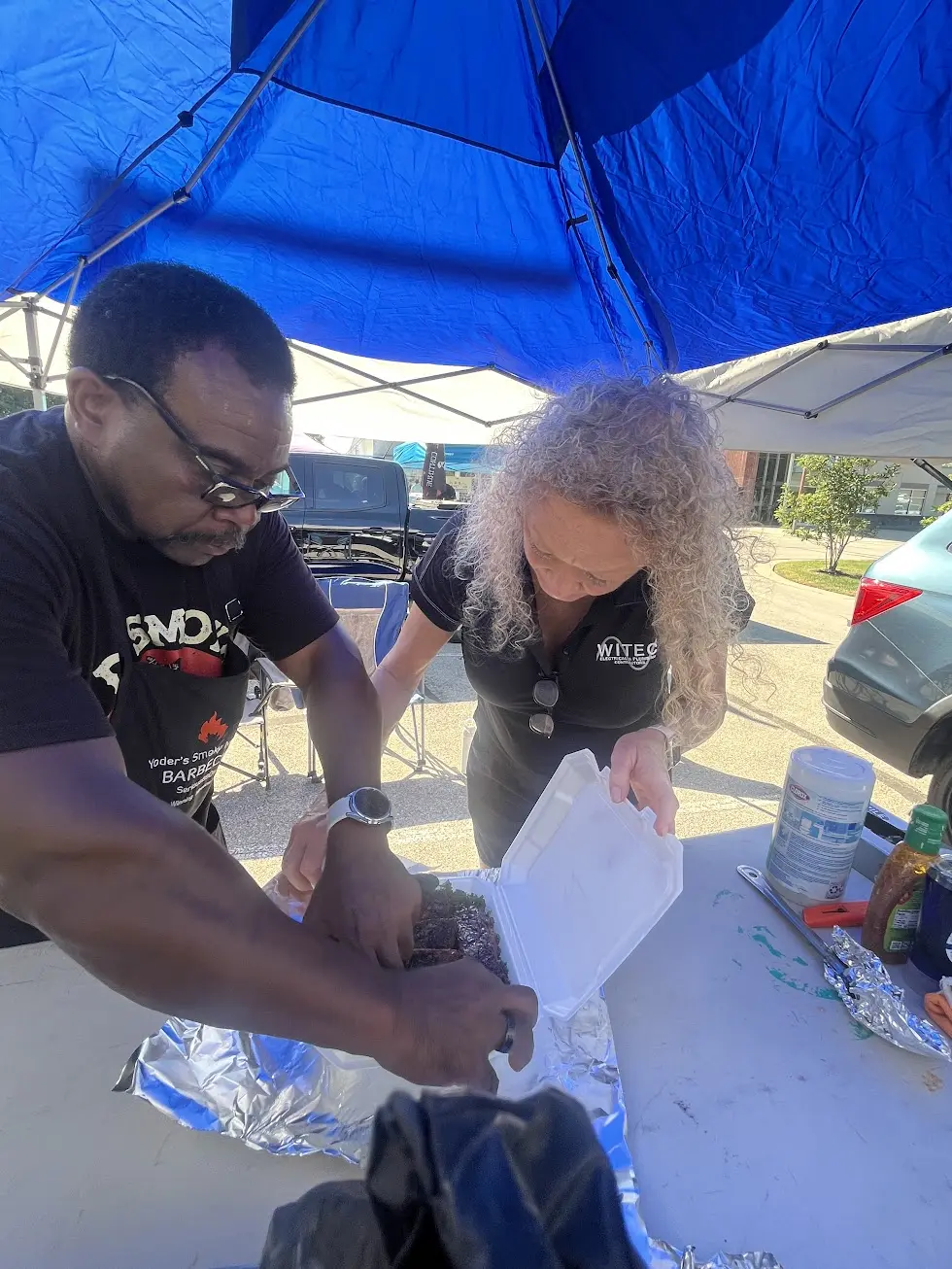 Team members boxing competition ribs for judging