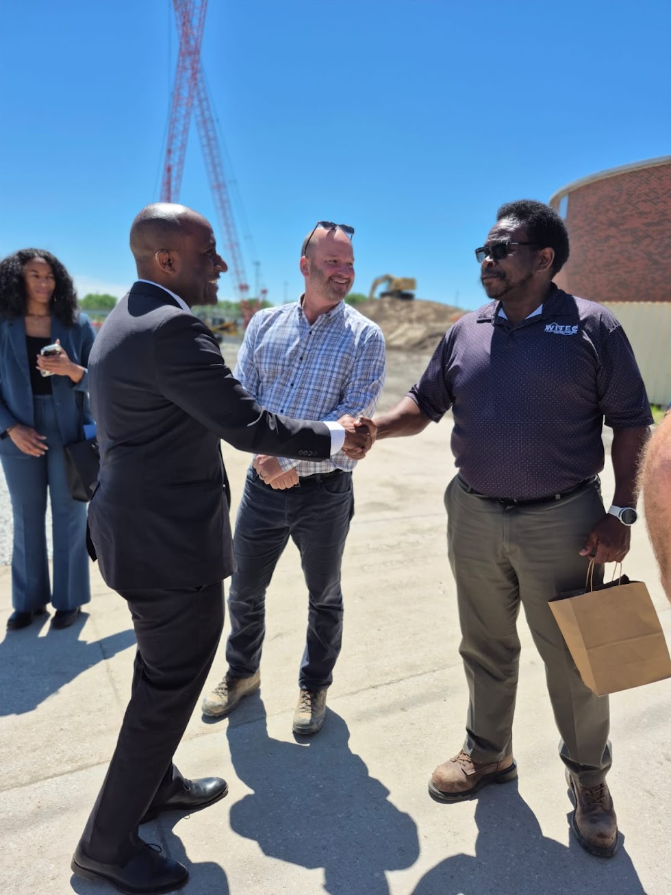 WITEC team member shaking hands with a guest at the Blue River Biosolids Facility opening