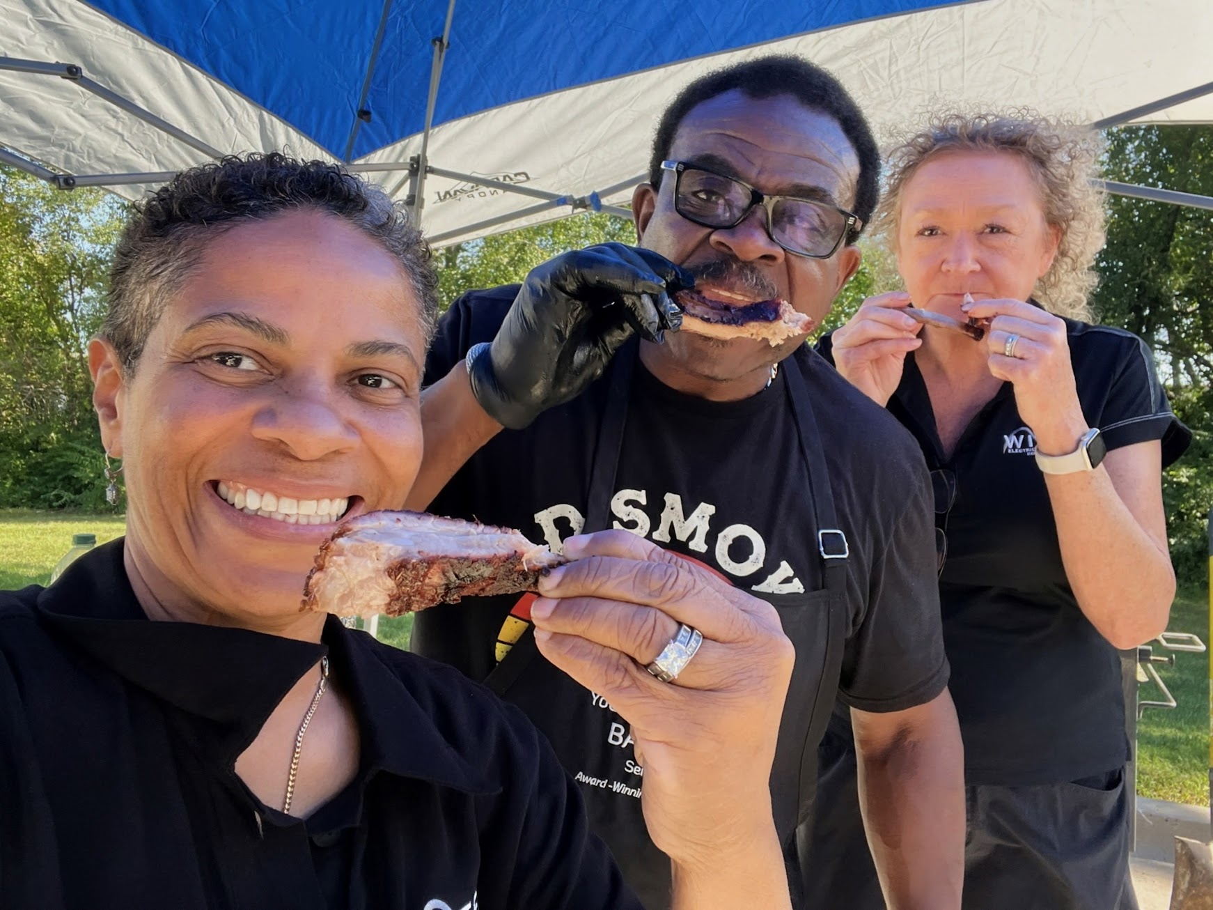 Three WITEC team members eating ribs together at the competition