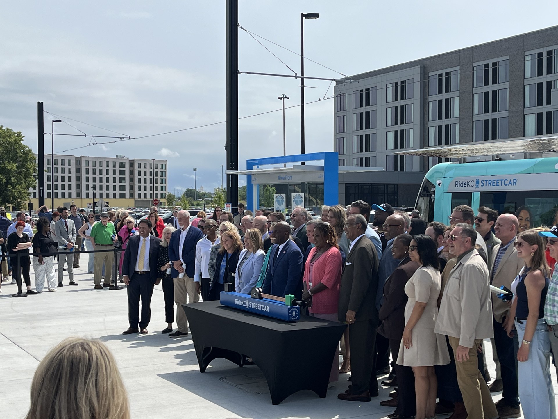 Opening celebration crowd beside a streetcar at Riverfront